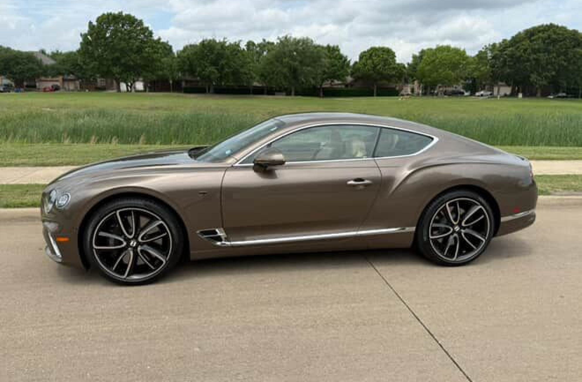 Luxurious Bentley GT available for rent in Dallas, shown in side profile