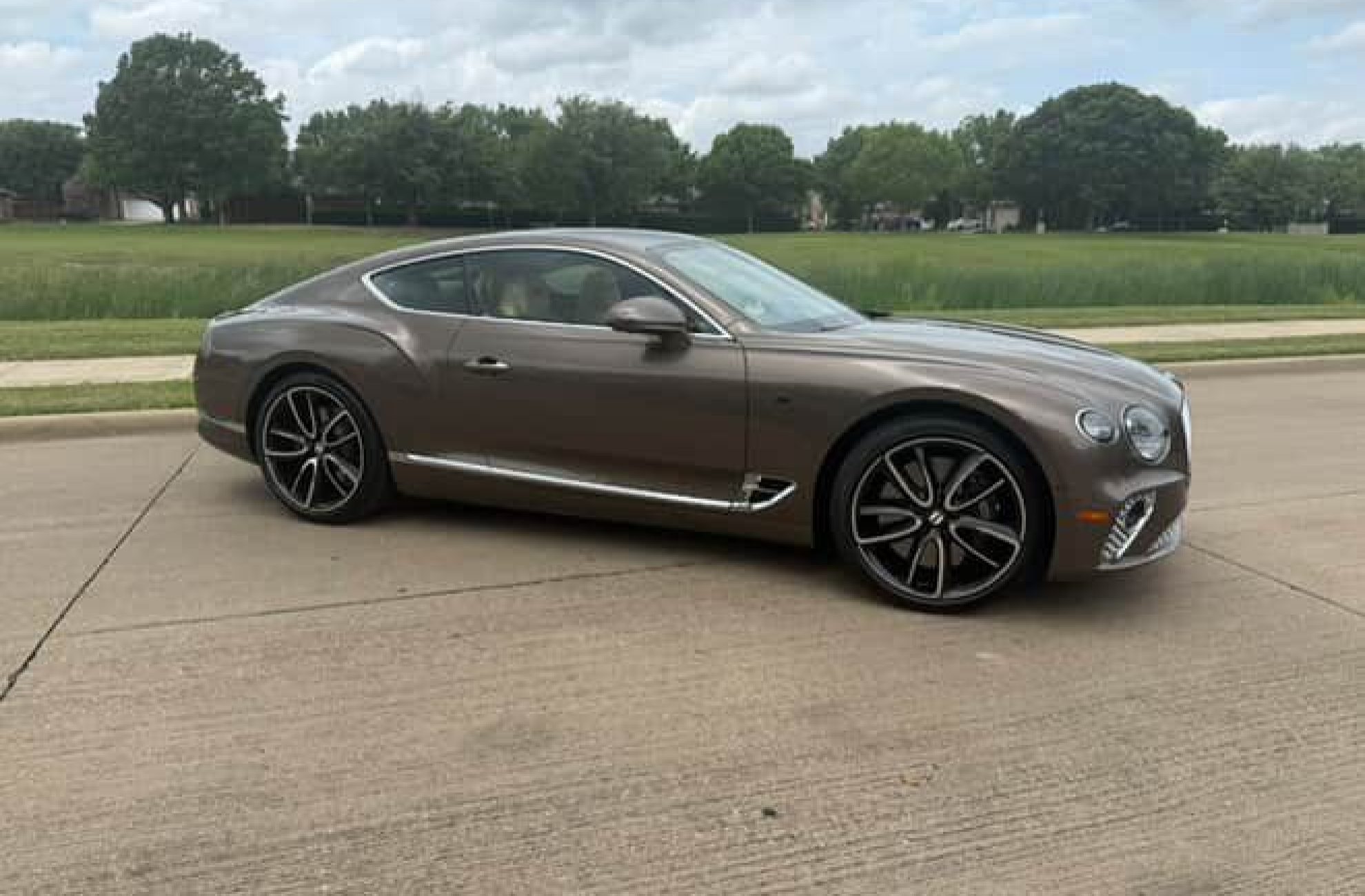 Front side view of Bentley GT coupe offered for rental in Dallas
